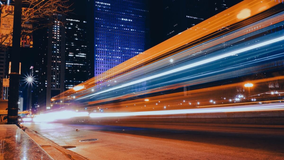 City train at night speeding by.