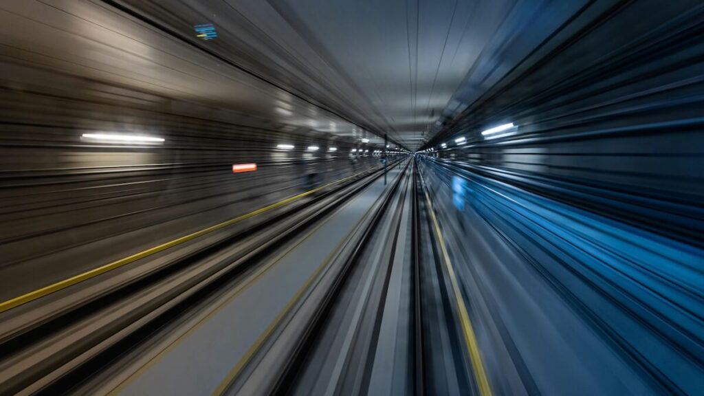 Train speeding down tunnel.